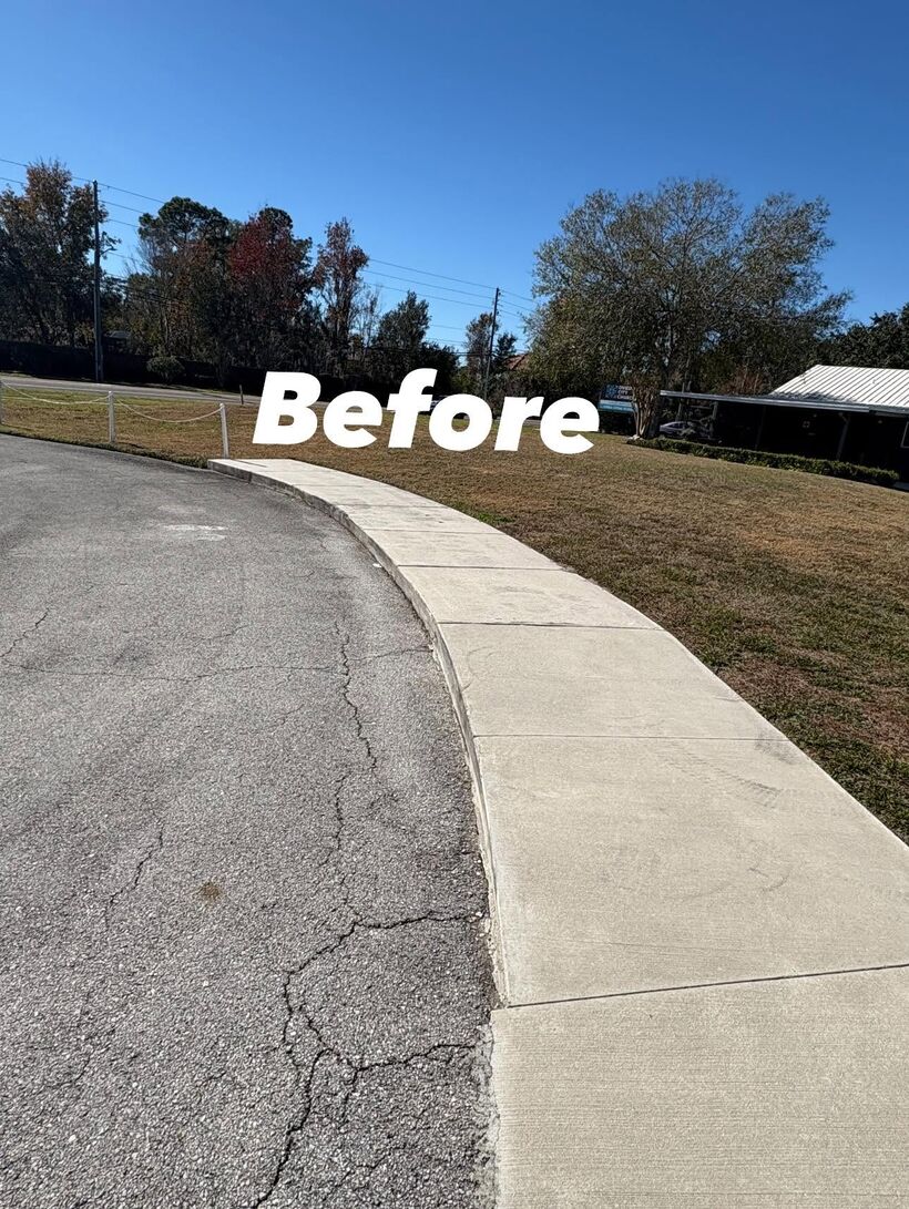 Weathered gray campus sidewalk curving along the drive at Oviedo City Church before pressure washing