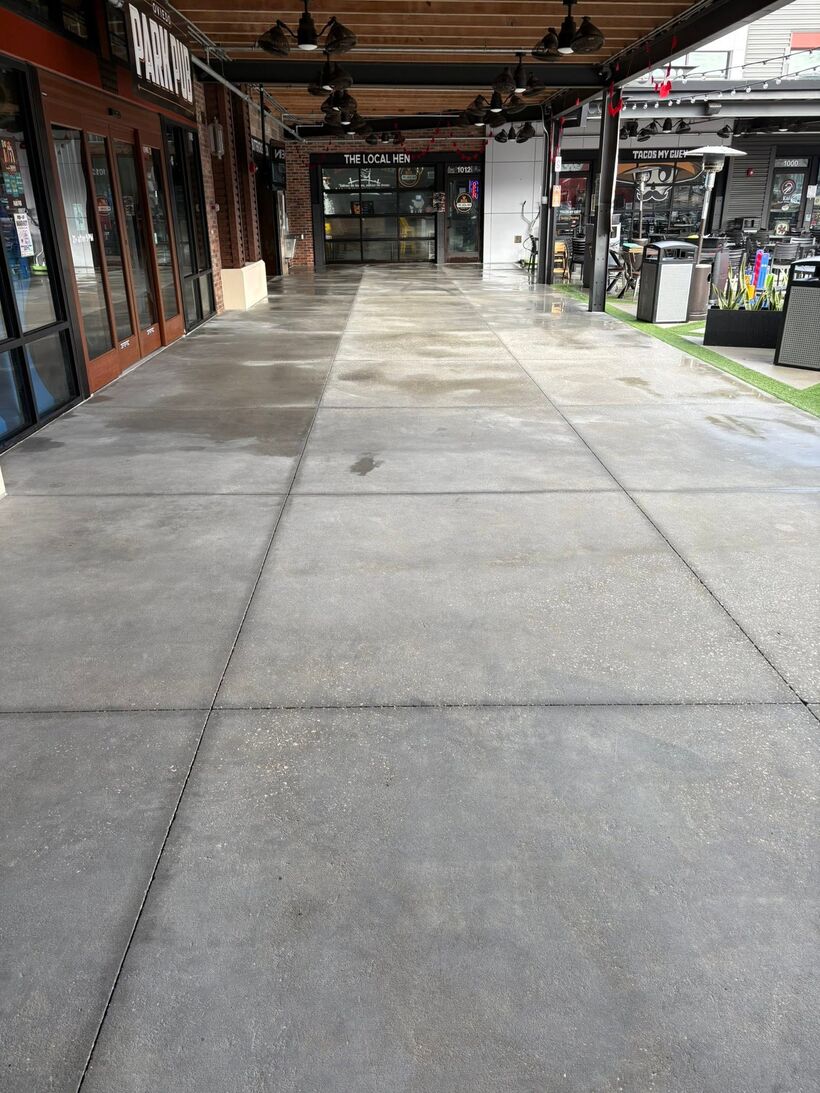 Long restaurant promenade with uniformly bright concrete after surface cleaning